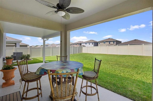 view of patio / terrace with a ceiling fan, a fenced backyard, a residential view, outdoor dining area, and central air condition unit