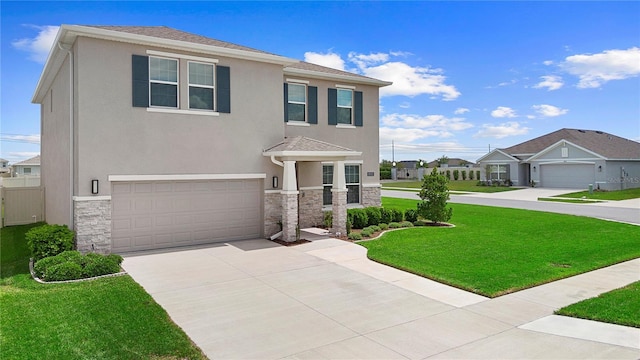 8953 SW 50th Ter, Ocala, FL 34476 - view of front of home with stucco siding, an attached garage, stone siding, driveway, and a front yard
