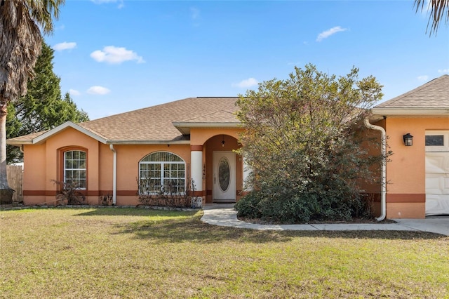 view of front of home featuring a garage and a front lawn