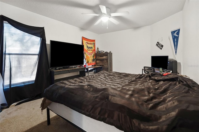 carpeted bedroom featuring ceiling fan and a textured ceiling