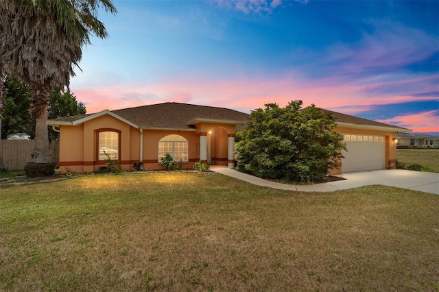 single story home with a yard and a garage