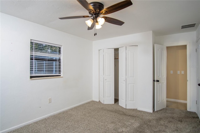 unfurnished bedroom with ceiling fan, carpet floors, visible vents, and baseboards