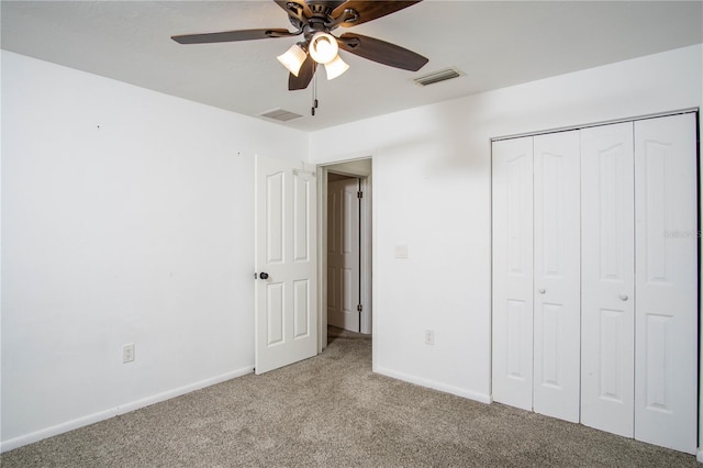 unfurnished bedroom with carpet, a closet, visible vents, and baseboards