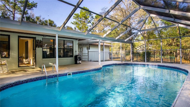 view of swimming pool featuring a lanai, a fenced in pool, and a patio