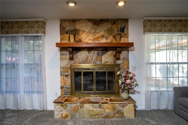 interior details with carpet floors and a fireplace