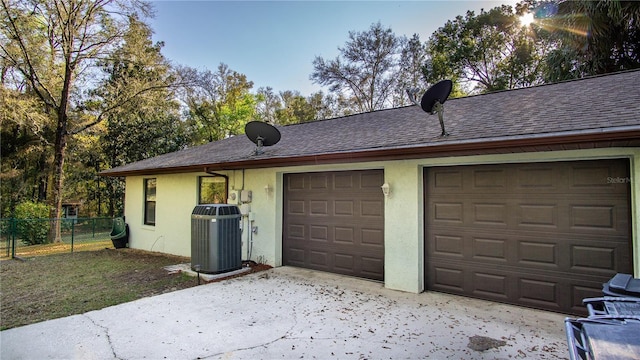 exterior space with fence and central air condition unit