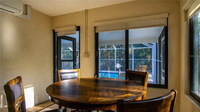 dining space with a textured wall, a wall mounted air conditioner, and a sunroom