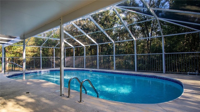 outdoor pool with a patio area, a lanai, and fence