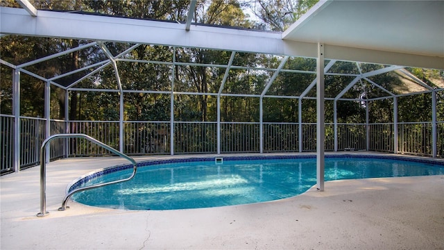 view of pool featuring a fenced in pool, a patio area, and glass enclosure