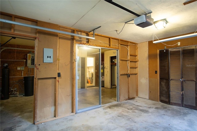 interior space featuring a garage, electric panel, and unfinished concrete flooring