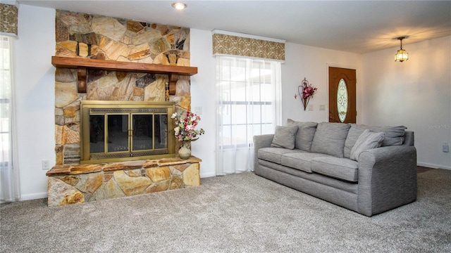 living room with carpet and a fireplace