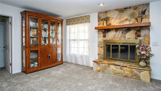 carpeted living area with a fireplace