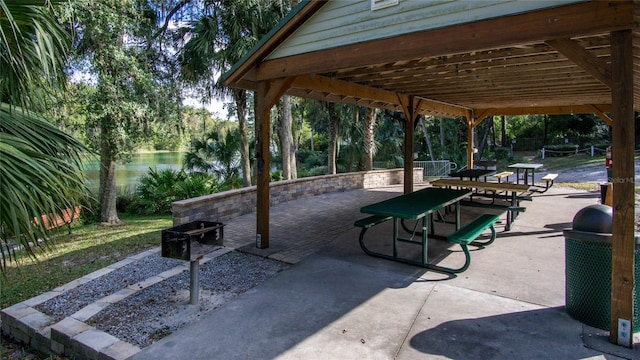 view of community with a water view and a patio area