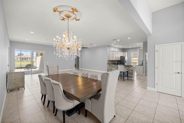 dining room featuring light tile patterned floors and an inviting chandelier