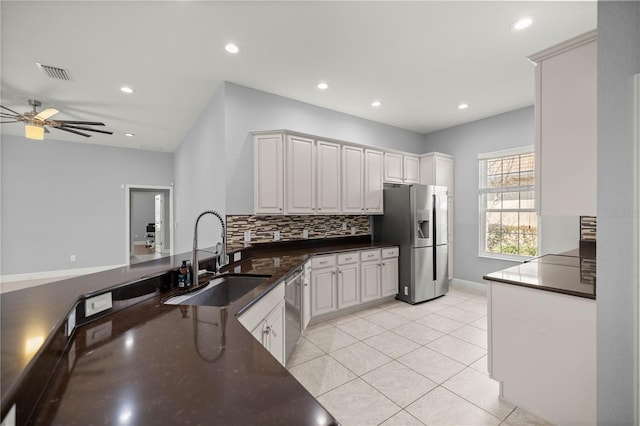 kitchen with white cabinetry, appliances with stainless steel finishes, kitchen peninsula, and sink