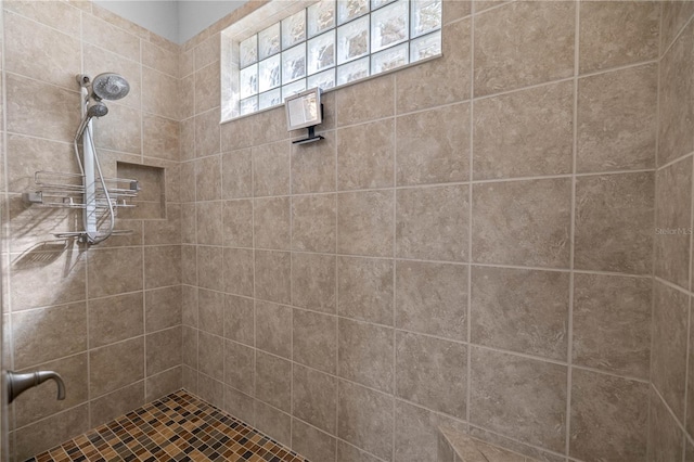 bathroom with tiled shower