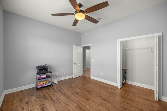 bedroom featuring hardwood / wood-style flooring, ceiling fan, and a closet