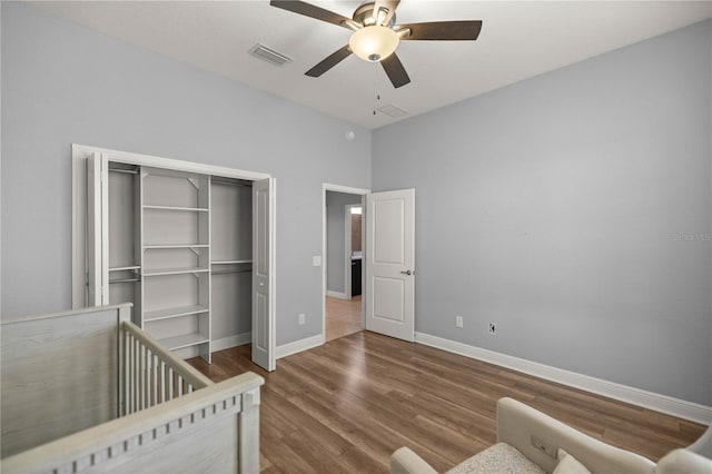 bedroom with wood-type flooring, a closet, and ceiling fan