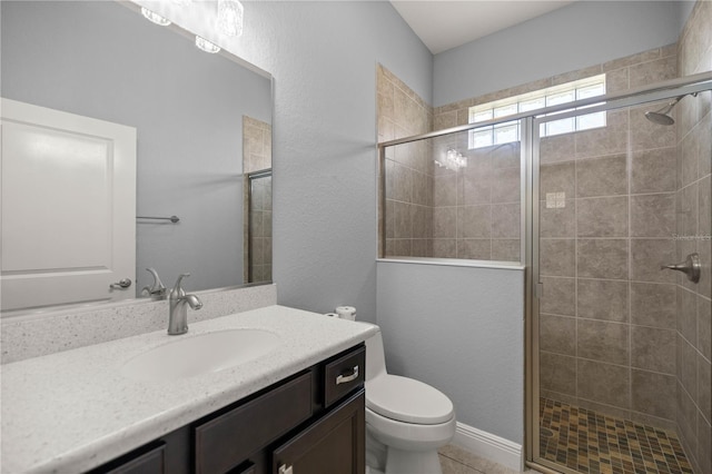 bathroom featuring vanity, an enclosed shower, and toilet