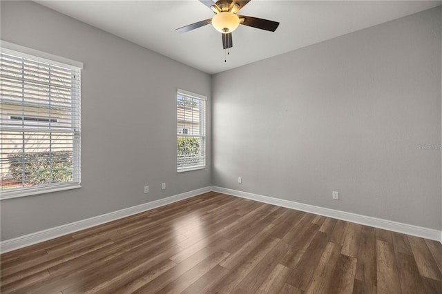 spare room with dark wood-type flooring and ceiling fan