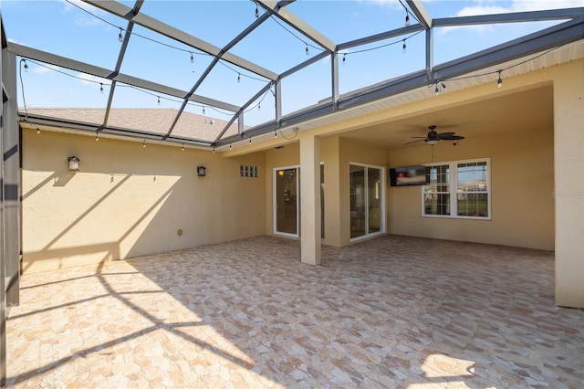 view of patio / terrace featuring a lanai and ceiling fan