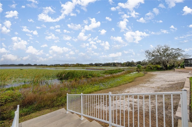 view of yard with a water view and a rural view