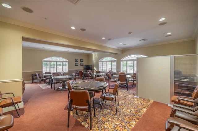 carpeted dining space featuring ornamental molding