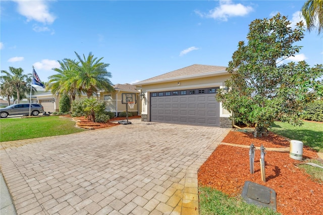 10138 Lake Miona Way, Oxford, FL 34484 - view of front facade featuring decorative driveway, a garage, a front yard, and stucco siding