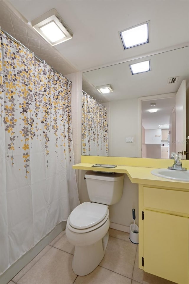 bathroom featuring vanity, curtained shower, tile patterned floors, and toilet