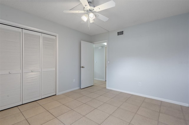 unfurnished bedroom featuring light tile patterned floors, a closet, and ceiling fan