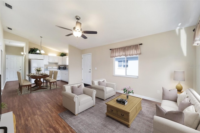 living room featuring dark wood-type flooring, vaulted ceiling, and ceiling fan