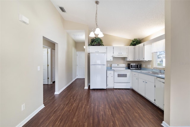 kitchen with sink, decorative light fixtures, vaulted ceiling, white appliances, and white cabinets