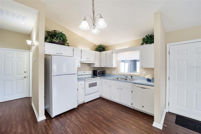 kitchen featuring sink, pendant lighting, white cabinets, and white appliances