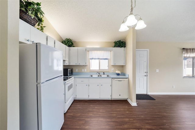 kitchen with white cabinetry, sink, pendant lighting, and white appliances