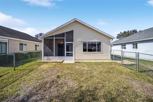 rear view of property with a sunroom and a lawn