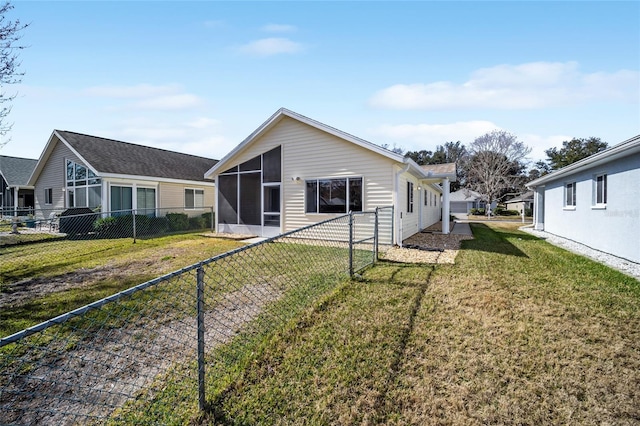 back of property featuring a sunroom and a yard