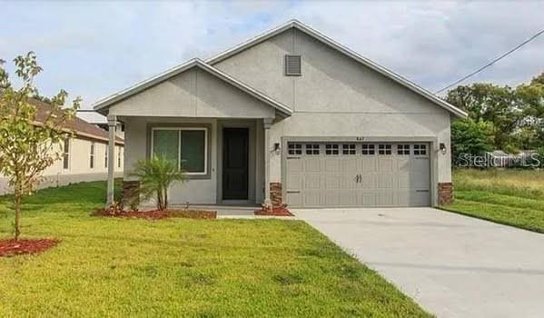 view of front of home with a garage and a front yard