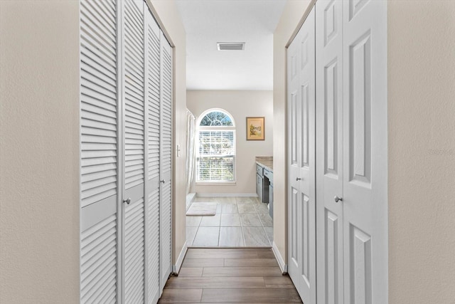 hallway with light hardwood / wood-style flooring