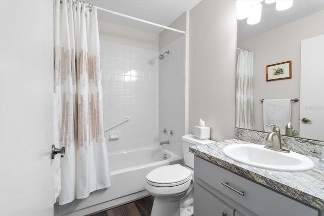 full bathroom with vanity, hardwood / wood-style flooring, toilet, and shower / bath combo with shower curtain