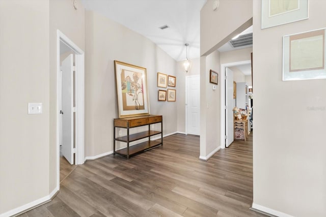 hallway with hardwood / wood-style flooring