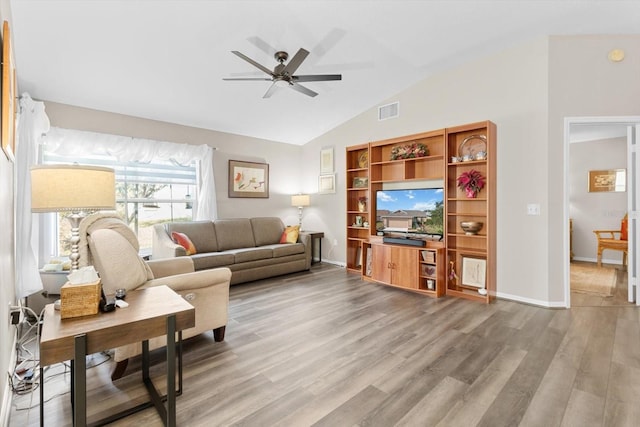 living room with lofted ceiling, hardwood / wood-style floors, and ceiling fan