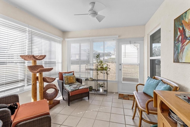 sunroom / solarium featuring ceiling fan