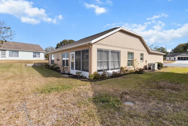 rear view of house featuring a yard