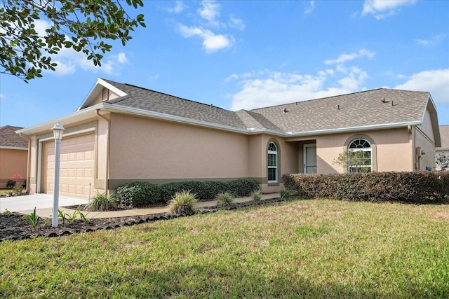 ranch-style home with a garage and a front lawn