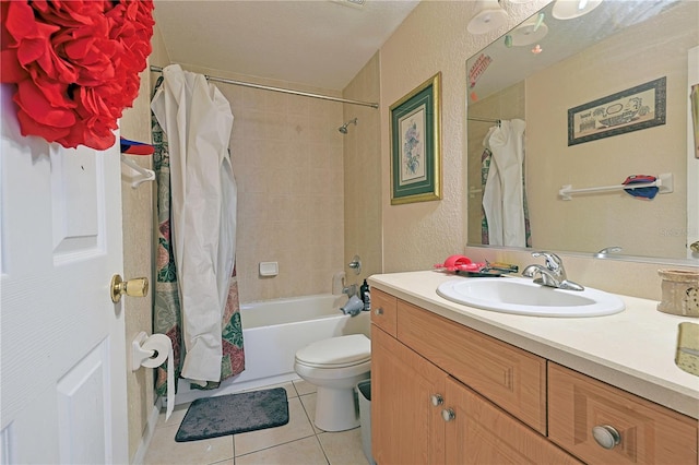 full bathroom featuring vanity, shower / bath combo, toilet, and tile patterned floors