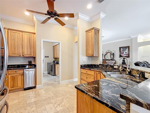 7688 SE 135th St, Summerfield, FL 34491 - kitchen featuring sink, crown molding, appliances with stainless steel finishes, dark stone countertops, and independent washer and dryer