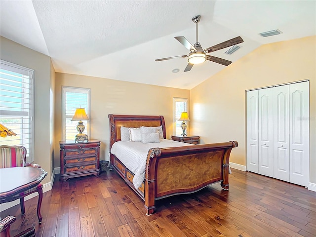 7688 SE 135th St, Summerfield, FL 34491 - bedroom with vaulted ceiling, ceiling fan, dark wood-type flooring, a textured ceiling, and a closet