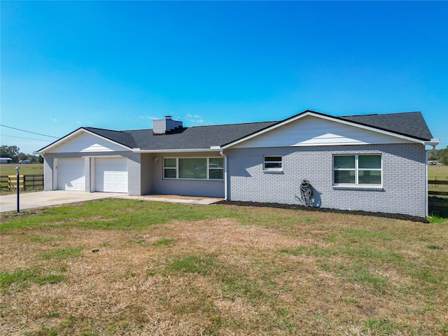 single story home with a garage and a front yard