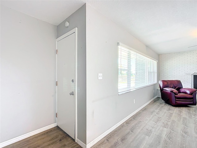 sitting room with a textured ceiling and light hardwood / wood-style flooring