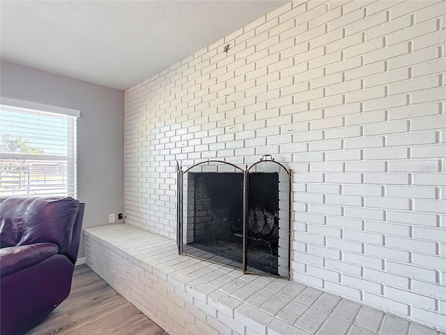 interior details with hardwood / wood-style flooring, a fireplace, and a textured ceiling